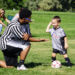 Young soccer player gets ready to slap hands with a referee.