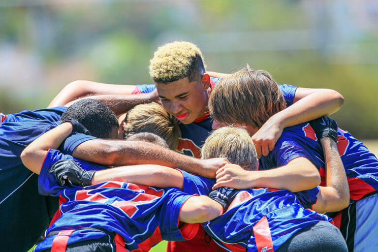 Boys form huddle during an i9 Sports event