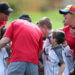 a group of players and coaches celebrating