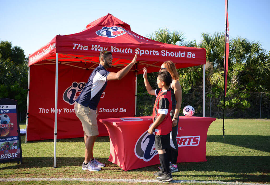 i9 Sports member gives a player a high-five