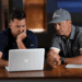 two men looking at computer