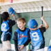 a group of boys in a dugout during a game