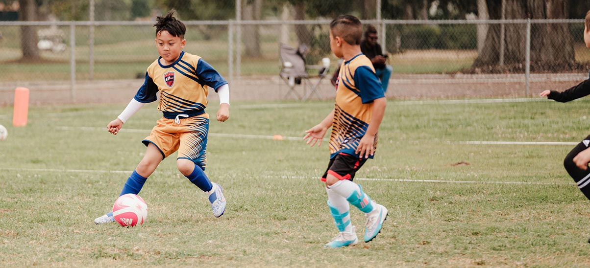 Kids out on the field playing soccer.