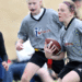 Two girls and a boy in the middle of a play during a game of flag football.