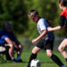 Boy kicks a soccer ball.