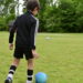 Young boy practicing soccer drills.